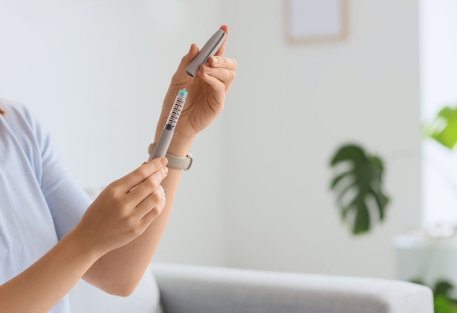 closeup of hands opening a syringe 